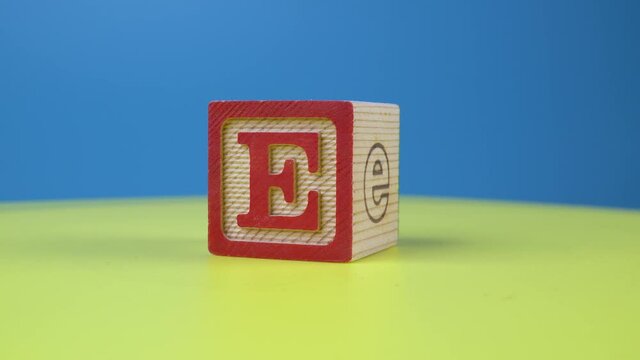 Close up shot letter "E" alphabet wooden block on surface