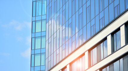 Futuristic facade of a modern office building clad in glass. Glass cladding panels and windows of modern building. An office building with geometry and perspective.