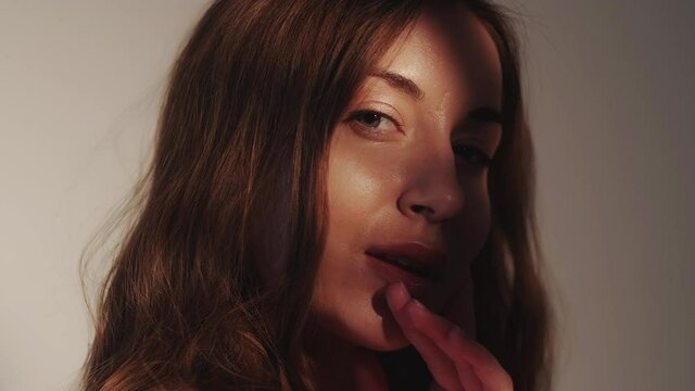 woman elegance model posing sunbeams hands face