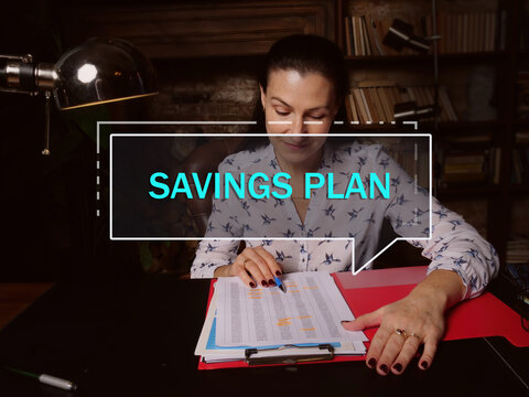  SAVINGS PLAN text in footnote block. Bookkeeping clerk checking financial report An employer-provided tax-deferred account typically used to save for retirement