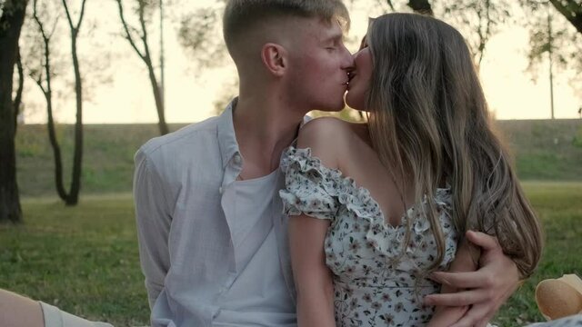 Young couple in love kissing at sunset slow motion video