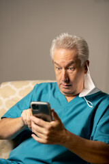 Fototapeta premium Photo of a doctor shocked while reading a phone text message
