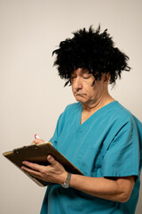Male nurse with crazy hair taking notes on a note pad