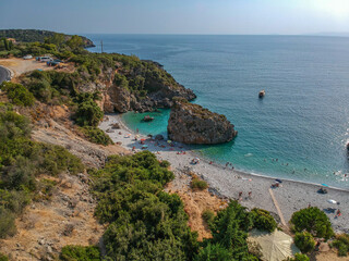 Aerial view of the famous rocky beach Foneas near Kardamyli village in the seaside Messenian Mani area during high tourist Summer period. Messenia, Peloponnese, Greece.