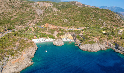 Aerial view of the famous rocky beach Foneas near Kardamyli village in the seaside Messenian Mani area during high tourist Summer period. Messenia, Peloponnese, Greece.