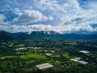 Fototapeta na wymiar Jarabacoa aerial view in the afternoon with low clouds and mountains, caribbean weather