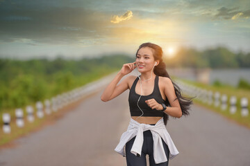 beautiful girl jogging beautiful woman running across the road at sunset