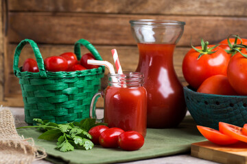 bowl and basket with ripe tomatoes next to tomato juice on the table