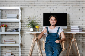 Young hipster beard Asian man happy in his new modern minimal startup office, concept for happy businessman at beginning