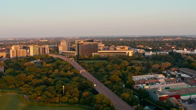 Circling drone shot of motorway entering city at sunset London