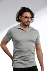 Middle-aged man, stylishly dressed in a gray T-shirt and glasses, business style, smart kezhl, handsome business man with glasses, business style concept, modern approach to men's fashion.