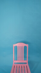 wooden pink chair on a blue background