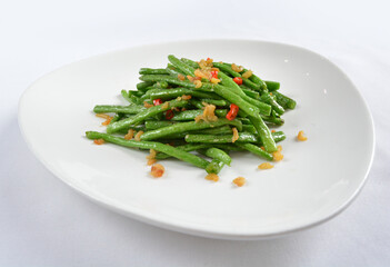 stir fried long green bean vegetables with dried shrimp in soy sauce in white background asian halal menu