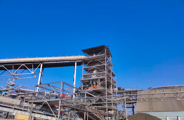 Loading corn for storage at a grain elevator and blue sky