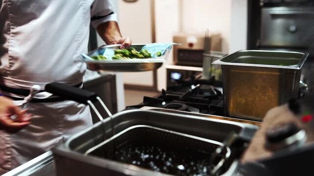 Straining excess oil from Spanish pimientos veggies