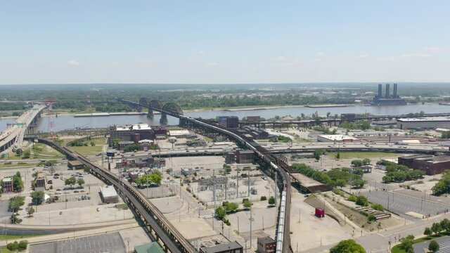 Aerial View of Train Carrying Commodities, Bulk Cargo. MacArthur Bridge in Background
