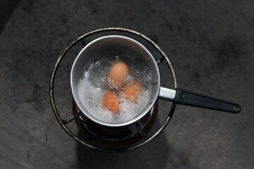 Boiled eggs in a pot of boiling water