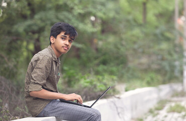 Portrait of Indian boy using Laptop for online class	
