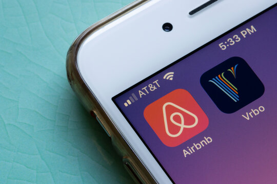 Portland, OR, USA - Aug 4, 2021: Airbnb and Vrbo mobile app icons are seen on an iPhone. Competitors in online vacation rental business concept.