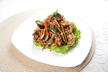 stir fried clam shell seafood with vegetable and chef dry spicy chilli sauce in white background asian halal menu