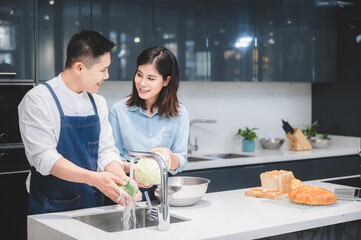 woman and man who young couple cooking food in kitchen at home, people are happy together with love about fresh vegetable lunch meal together, cheerful and smiling to healthy lifestyle