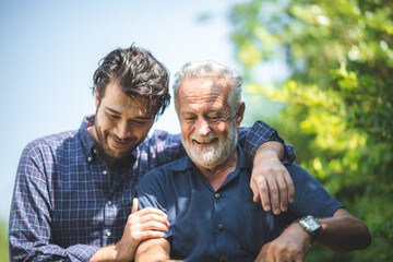 caucasian senior father and adult son are hugging together at home, generation family are happy with people love, male mature, old person man, elderly grandfather smiling living at the house - Powered by Adobe