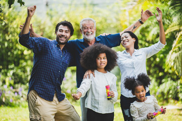 senior father and hipster adult son are happy love and relaxing together at nature outdoor park, mature family of elderly caucasian beard man playing fun with family in retirement leisure time