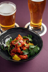 Japanese karaage chicken dish with beer on a purple background