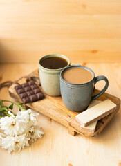 cup of coffee with cookies and flowers