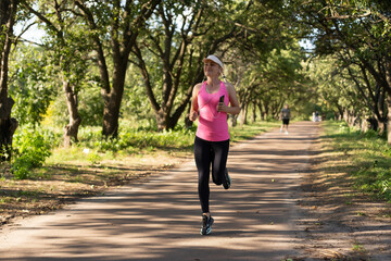 Running woman. Female Runner Jogging during Outdoor Workout in a Park.