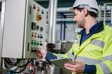 professional technician engineer working to control electrical power and safety service system,...