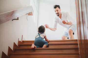 Fototapeta premium little toddler children with first walk step with stairs at home, small baby person are happy to play and learn to crawling with family, cute infant boy having fun and childhood care