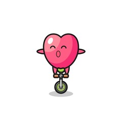 The cute heart symbol character is riding a circus bike