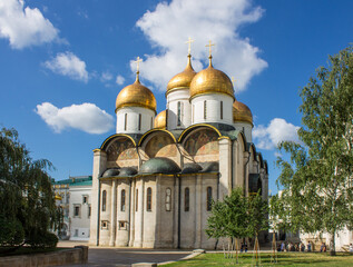 Cathedral of the Assumption of the Most Holy Theotokos with golden domes in the Kremlin on Cathedral Square on a sunny summer day in Moscow Russia