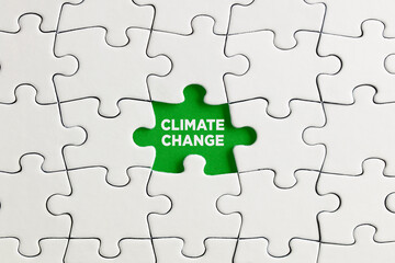 Green missing puzzle piece with the word climate change. Deforestation and the damages of climate change