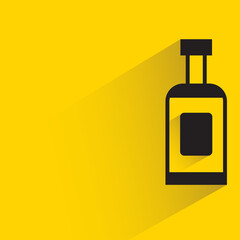 alcohol bottle with shadow on yellow background