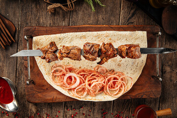 Grilled georgian mutton meat shashlik skewers with onion