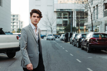 Fototapeta na wymiar young man in casual suit walking down a street