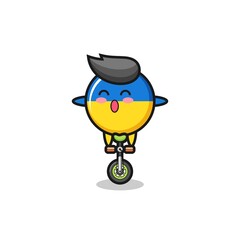 The cute ukraine flag badge character is riding a circus bike