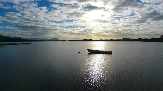 Canoe anchored on the lake at sunset.