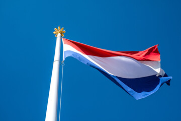 Dutch flag on top of the former royal palace Het Loo in Apeldoorn, Gelderland Province, The Netherlands