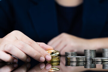 Close up of businesswoman holding some pieces of golden Bitcoin token