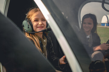 Smiling tween girl in pilot headset sitting in helicopter cockpit © nazarovsergey