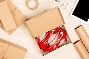 fashionable female shoes in a box on a colored background top view
