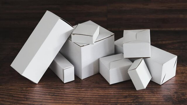shipping industry and online shopping, group of white plain delivery parcels piled up on wooden surface
