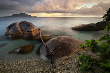 a rocky shore next to a body of water