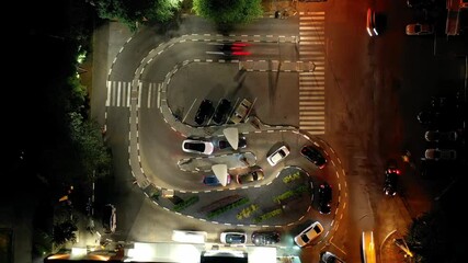 Night Timelapse: traffic on car service line of a fast food restaurant, top view.