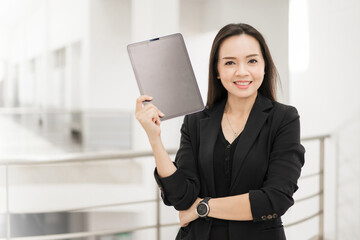 Portrait stock photo of a confident cheerful Asian businesswoman professional in black business...