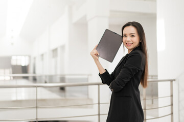 Portrait stock photo of a confident cheerful Asian businesswoman professional in black business...