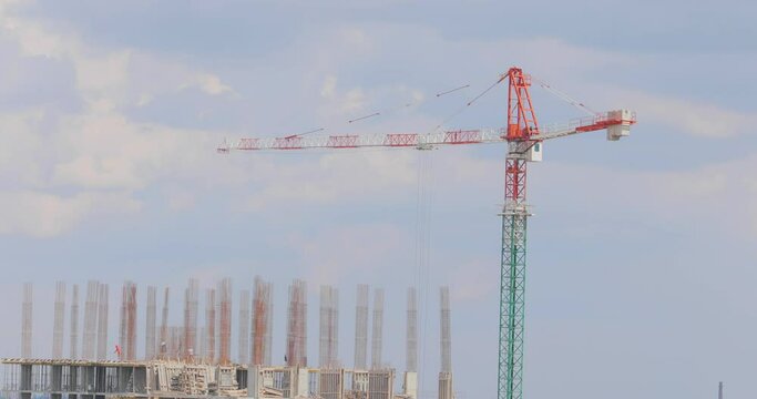 Tower crane at a construction site. Construction crane. Construction of a multi-storey residential building.